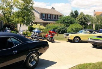 A driveway full of classic cars