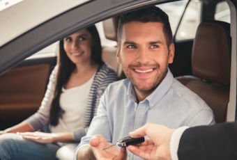 Young couple in their new car