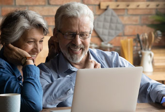 Mature couple shopping for home insurance online